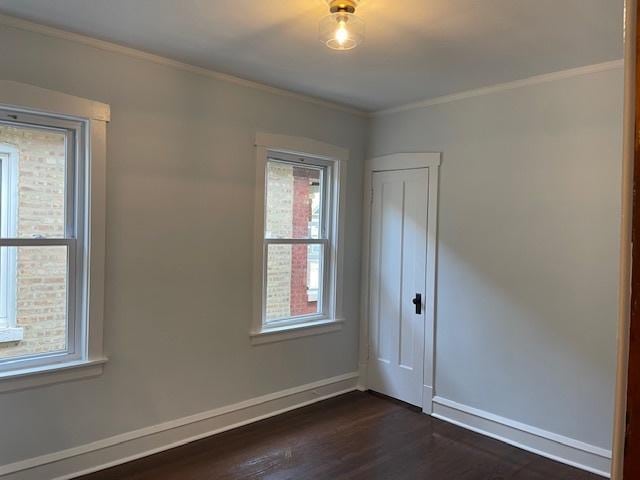 1404 Scoville Ave, Berwyn, IL 60402 - empty room featuring dark wood finished floors and crown molding