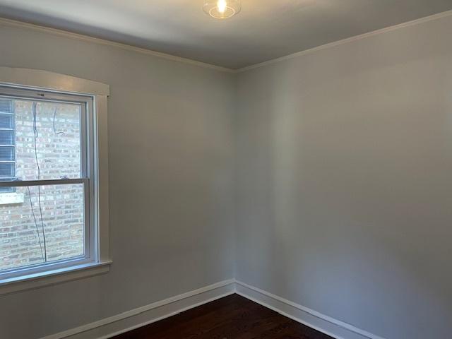 1404 Scoville Ave, Berwyn, IL 60402 - unfurnished room with dark wood-type flooring and crown molding