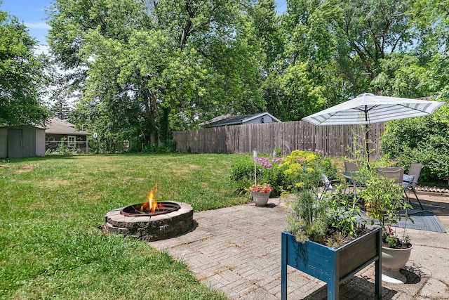 911 N 9th St, Dekalb, IL 60115 - fenced backyard featuring a fire pit and a patio area