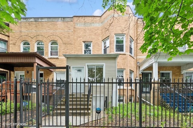 4229 S Prairie Ave, Chicago, IL 60653 - italianate-style house with a fenced front yard, brick siding, and a gate