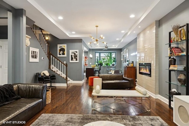 4229 S Prairie Ave, Chicago, IL 60653 - living room with wood finished floors, a chandelier, stairs, a tiled fireplace, and a tray ceiling