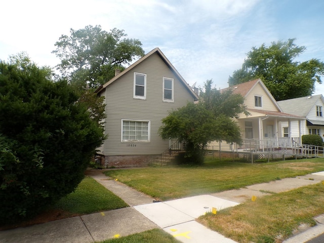 12934 Mozart St, Blue Island, IL 60406 - view of front of house featuring a front lawn and covered porch
