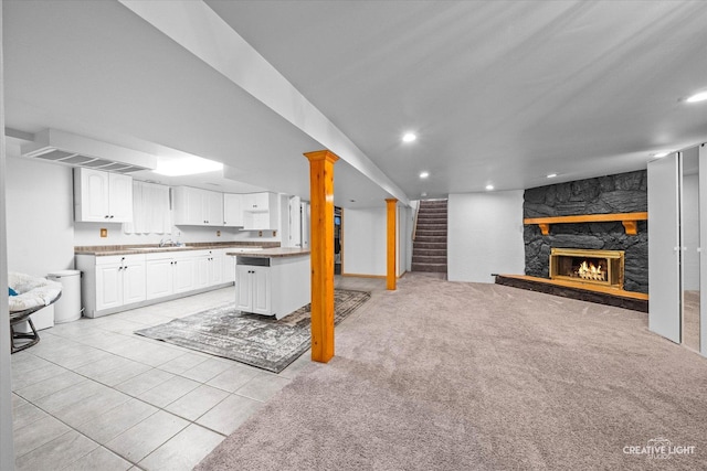 92 Neil Rd, Sugar Grove, IL 60554 - unfurnished living room featuring a stone fireplace, recessed lighting, stairs, and light tile patterned floors