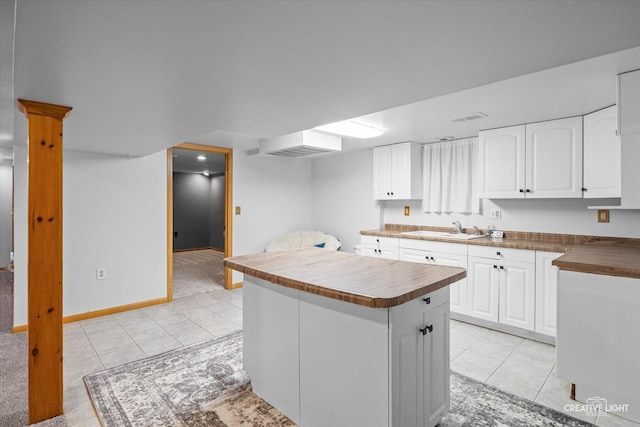 92 Neil Rd, Sugar Grove, IL 60554 - kitchen with light tile patterned flooring, a center island, and white cabinetry