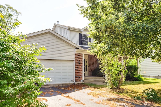 1021 Autumn Dr, Antioch, IL 60002 - view of front of house featuring an attached garage, brick siding, and asphalt driveway