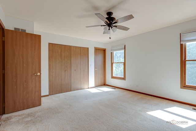 1021 Autumn Dr, Antioch, IL 60002 - unfurnished bedroom with carpet, multiple windows, multiple closets, and ceiling fan