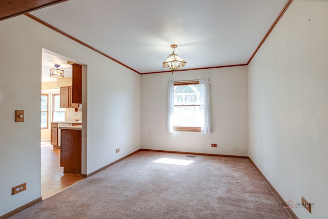 1021 Autumn Dr, Antioch, IL 60002 - unfurnished room featuring light colored carpet, crown molding, healthy amount of natural light, and a chandelier