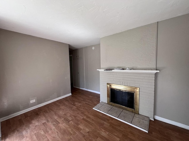 252 Mantua St, Park Forest, IL 60466 - unfurnished living room with wood finished floors and a brick fireplace