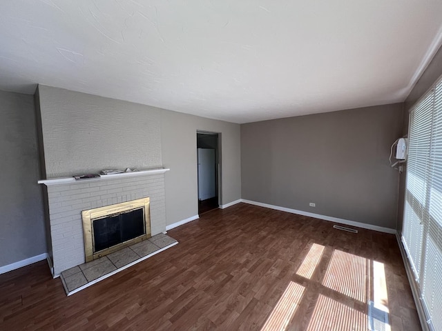 252 Mantua St, Park Forest, IL 60466 - unfurnished living room with wood finished floors and a brick fireplace