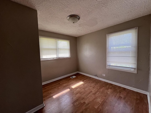 252 Mantua St, Park Forest, IL 60466 - spare room with dark wood finished floors and a textured ceiling
