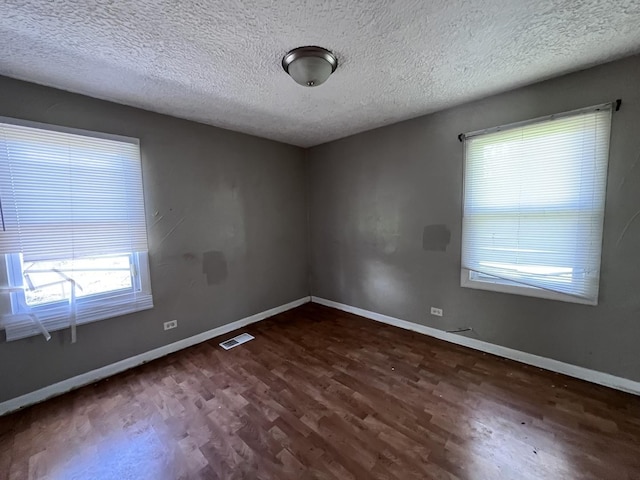 252 Mantua St, Park Forest, IL 60466 - unfurnished room featuring dark wood-style flooring and a textured ceiling
