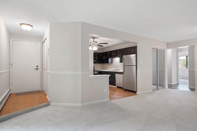 5340 Waterbury Ct Unit 2103, Crestwood, IL 60418 - kitchen featuring appliances with stainless steel finishes, dark cabinets, tasteful backsplash, ceiling fan, and light carpet