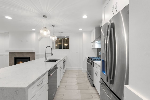 5312 S Woodlawn Ave Unit 1, Chicago, IL 60615 - kitchen with appliances with stainless steel finishes, wall chimney exhaust hood, recessed lighting, light stone counters, and a fireplace