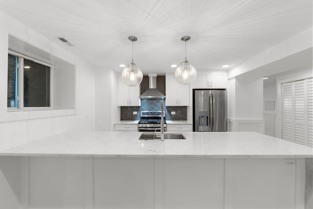 5312 S Woodlawn Ave Unit 1, Chicago, IL 60615 - kitchen with wall chimney range hood, appliances with stainless steel finishes, white cabinetry, tasteful backsplash, and recessed lighting