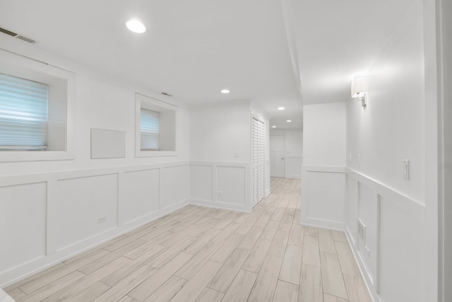 5312 S Woodlawn Ave Unit 1, Chicago, IL 60615 - empty room featuring a decorative wall, recessed lighting, light wood-style floors, and wainscoting