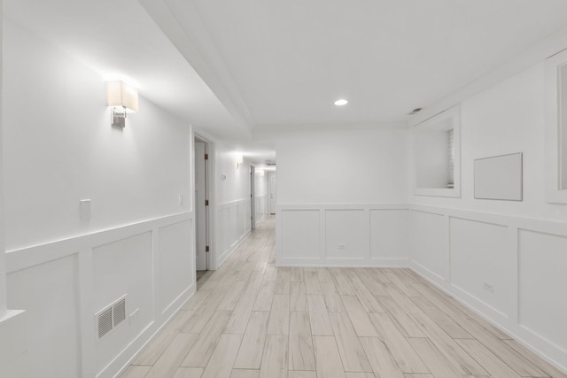 5312 S Woodlawn Ave Unit 1, Chicago, IL 60615 - empty room with a decorative wall, light wood-style flooring, wainscoting, and recessed lighting