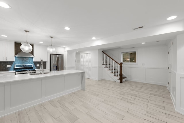 5312 S Woodlawn Ave Unit 1, Chicago, IL 60615 - kitchen featuring stainless steel appliances, wall chimney exhaust hood, backsplash, white cabinetry, and recessed lighting