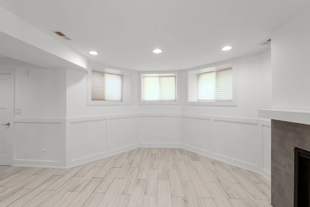5312 S Woodlawn Ave Unit 1, Chicago, IL 60615 - basement featuring a decorative wall, light wood-style floors, recessed lighting, and a fireplace