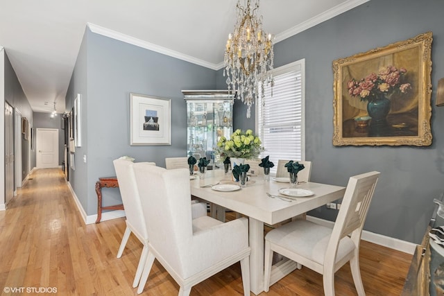 2848 N Burling St Unit 1, Chicago, IL 60657 - dining area with a chandelier, light wood-style flooring, and crown molding