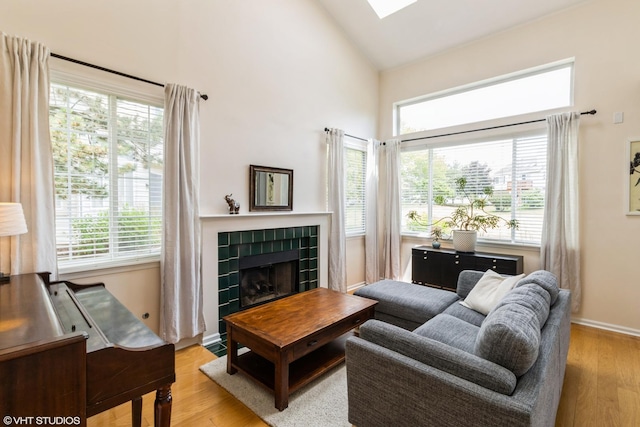 253 Sierra Pass, Schaumburg, IL 60194 - living area featuring a fireplace, plenty of natural light, light wood-style floors, and high vaulted ceiling