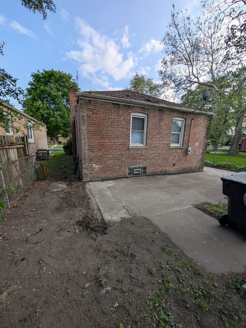 520 W 129th Pl, Chicago, IL 60628 - rear view of house featuring brick siding and a patio area
