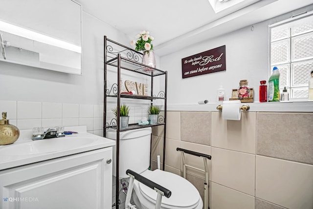 2924 N Mulligan Ave, Chicago, IL 60634 - half bath with tile walls, vanity, and a wainscoted wall