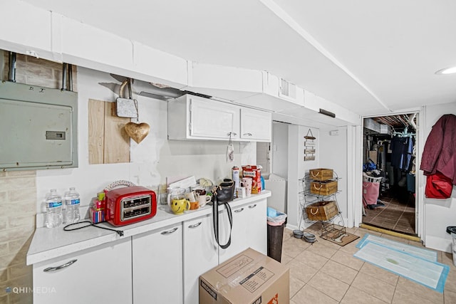 2924 N Mulligan Ave, Chicago, IL 60634 - kitchen featuring light countertops, light tile patterned floors, electric panel, and white cabinetry