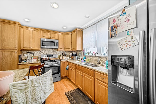 2924 N Mulligan Ave, Chicago, IL 60634 - kitchen with appliances with stainless steel finishes, tasteful backsplash, light stone counters, recessed lighting, and light wood finished floors