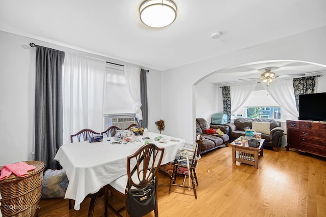 2924 N Mulligan Ave, Chicago, IL 60634 - dining room featuring arched walkways, a ceiling fan, light wood-style flooring, and cooling unit