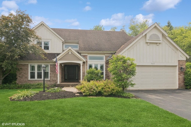 904 Warwick Ln, Lake Zurich, IL 60047 - view of front of home featuring board and batten siding, asphalt driveway, and brick siding