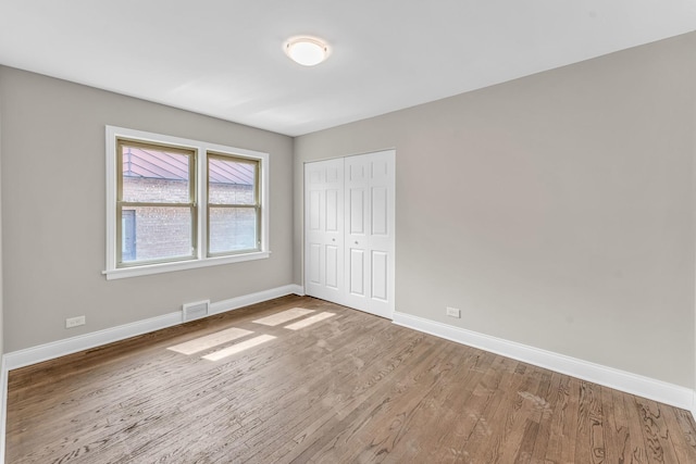10026 S Spaulding Ave, Evergreen Park, IL 60805 - unfurnished bedroom with wood finished floors and a closet