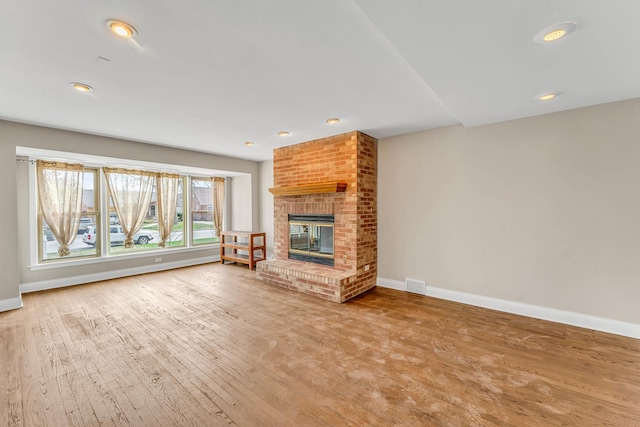 10026 S Spaulding Ave, Evergreen Park, IL 60805 - unfurnished living room with wood finished floors, a brick fireplace, and recessed lighting
