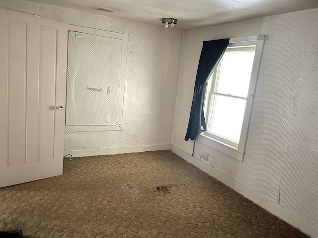 218 S Oneca St, Tonica, IL 61370 - carpeted empty room featuring baseboards