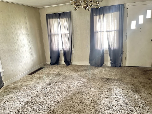 218 S Oneca St, Tonica, IL 61370 - carpeted foyer featuring a chandelier and wooden walls