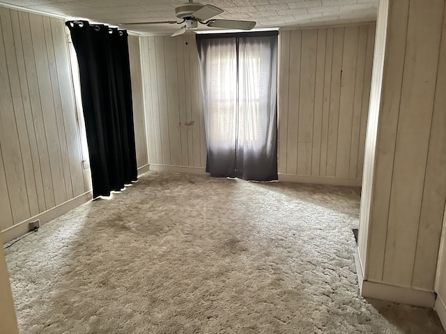 218 S Oneca St, Tonica, IL 61370 - carpeted spare room with a ceiling fan and wood walls
