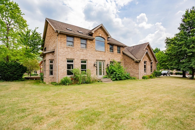 115 E Woodlawn Rd, New Lenox, IL 60451 - view of front of house featuring brick siding, a front yard, and a shingled roof