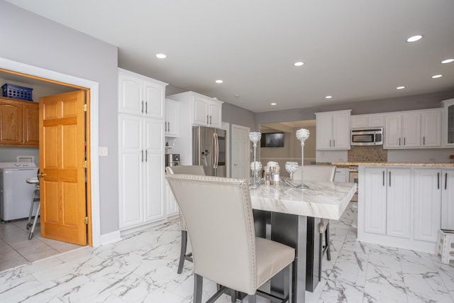 115 E Woodlawn Rd, New Lenox, IL 60451 - dining space featuring light marble finish floors, recessed lighting, and washer / clothes dryer