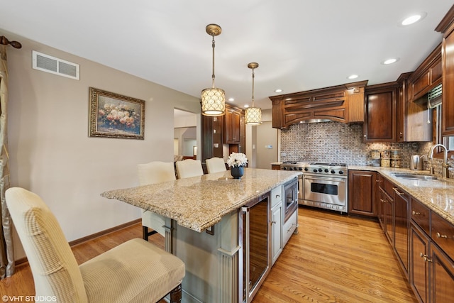 11522 Ridgewood Ln, Burr Ridge, IL 60527 - kitchen with stainless steel appliances, beverage cooler, a kitchen breakfast bar, premium range hood, and decorative backsplash
