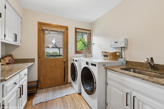 11522 Ridgewood Ln, Burr Ridge, IL 60527 - laundry area featuring washing machine and clothes dryer, cabinet space, and light wood-style floors