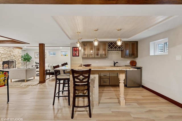 11522 Ridgewood Ln, Burr Ridge, IL 60527 - bar area featuring light wood finished floors, a fireplace, hanging light fixtures, and refrigerator