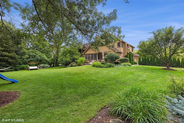 11522 Ridgewood Ln, Burr Ridge, IL 60527 - view of grassy yard with a sunroom and a playground