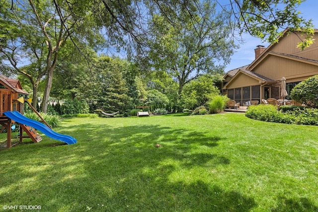 11522 Ridgewood Ln, Burr Ridge, IL 60527 - view of green lawn with a sunroom and a playground