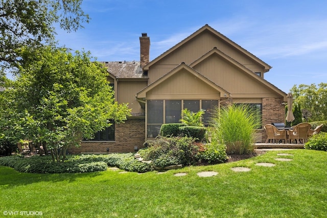 11522 Ridgewood Ln, Burr Ridge, IL 60527 - view of property exterior with a chimney, brick siding, and a yard