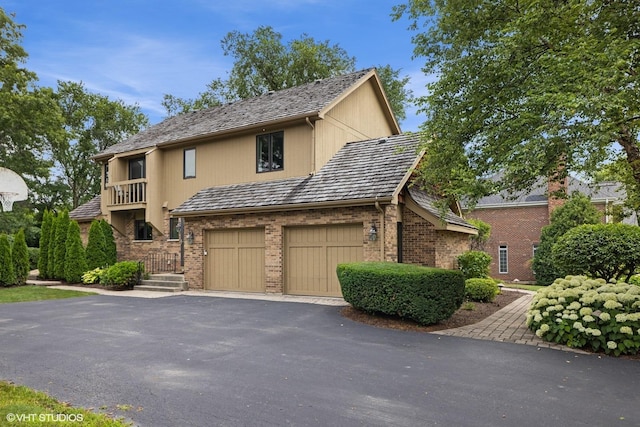 11522 Ridgewood Ln, Burr Ridge, IL 60527 - view of front of home featuring a garage, brick siding, a balcony, and driveway