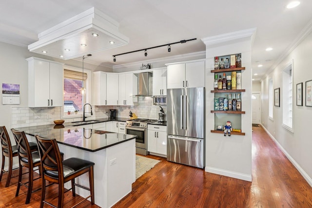 1431 N Artesian Ave Unit 1, Chicago, IL 60622 - kitchen with appliances with stainless steel finishes, wall chimney exhaust hood, dark countertops, a peninsula, and open shelves