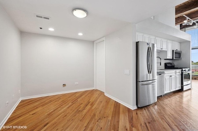 2614 N Clybourn Ave Unit 311, Chicago, IL 60614 - kitchen featuring appliances with stainless steel finishes, white cabinets, light wood-style floors, recessed lighting, and light countertops