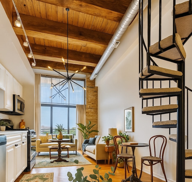 2614 N Clybourn Ave Unit 311, Chicago, IL 60614 - living area featuring a high ceiling, light wood finished floors, a wood ceiling with exposed beams, and a chandelier
