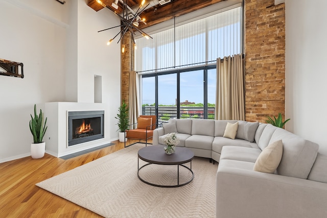 2614 N Clybourn Ave Unit 311, Chicago, IL 60614 - living area featuring a high ceiling, a chandelier, wood finished floors, and a lit fireplace