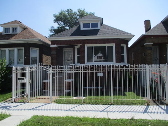 7319 S Claremont Ave, Chicago, IL 60636 - bungalow-style home with a fenced front yard, brick siding, and a gate