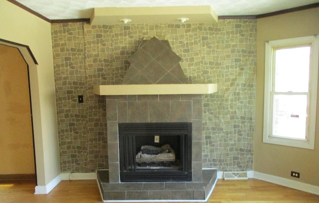7319 S Claremont Ave, Chicago, IL 60636 - detailed view of ornamental molding, wood finished floors, and a tiled fireplace